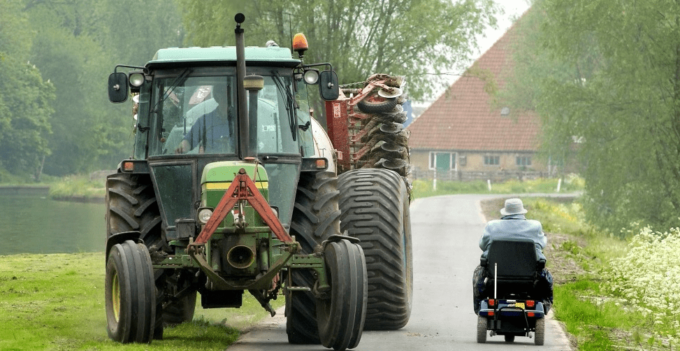 Landbouwverkeer met aanhanger en scootmobiel maken gebruik van dezelfde weg